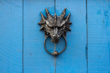Snarling Dragon Door Knocker Guarding A Door