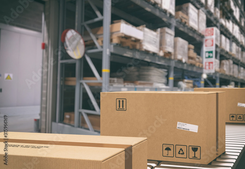 Cuadros en Lienzo Cardboard boxes on conveyor rollers inside a warehouse ready to be shipped by co