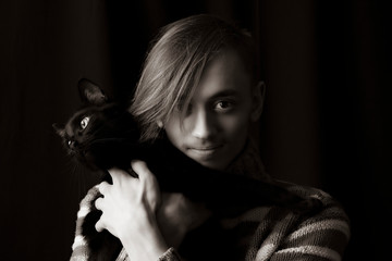  Young guy with a black cat posing in front of the camera