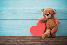 Teddy Bear With Red Heart On Old Wooden Background. Valentine's