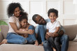 © fizkes - Happy family listening to little funny boy.