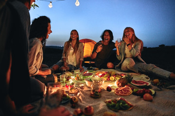 Group of friends making barbecue in the nature.