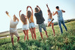 © HBS - People group outdoor countryside raise arms rear back view friends holding hands up summer day