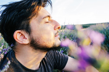 Young man in a field of flowers