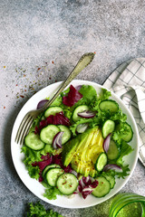 Wall Mural - Fresh vegetable salad with avocado and cucumber. Top view with copy space.