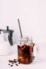 Wall Mural - Iced coffee drink on glass jar with straw.