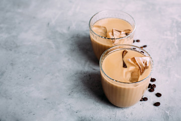 Wall Mural - Iced Coffee with Vanilla Cardamom Almond Milk on gray stone background