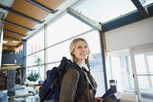 Smiling Woman With Backpack In Airport