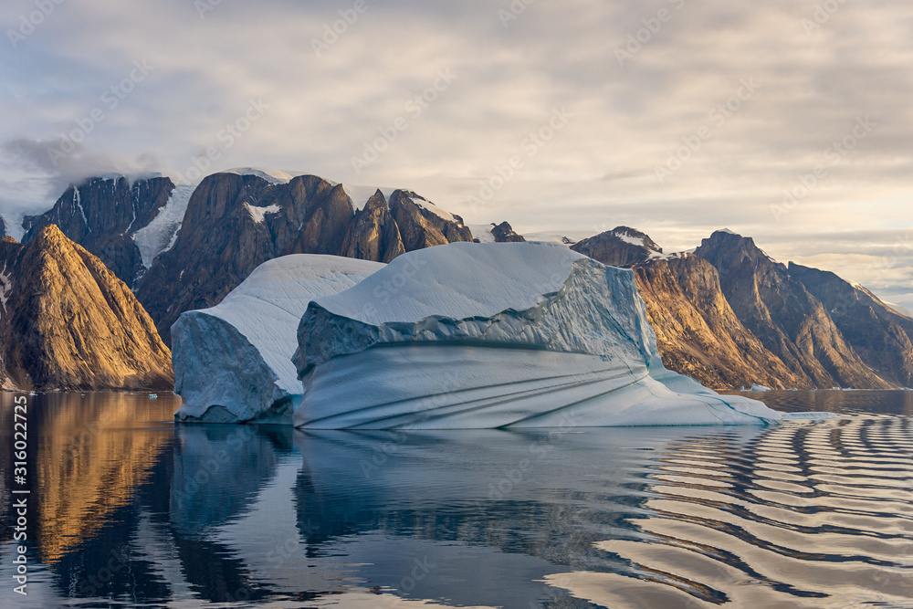Beautiful view to iceberg at sunset from expedition vessel in Greenland fjord - obrazy, fototapety, plakaty 