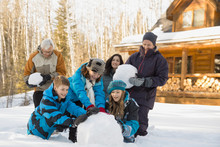 Multi-generation Family Making Snowman Together