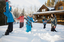 Playful Family Having Snowball Fight