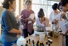 Women With Notebooks Learning About Essential Oils