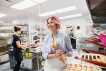Smiling Pastry Chef Piping Cookies With Pink Icing