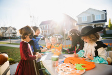 Kids In Halloween Costumes Doing Crafts Front Yard