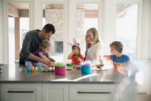 Family Coloring Easter Eggs In Kitchen