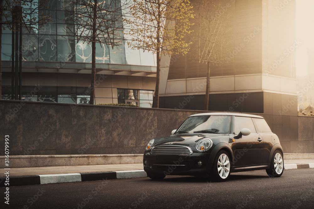 Moscow, Russia - April 27, 2019: MINI Cooper car is parked near office buildings at International Business Center Moscow-city