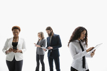 Business People Using Cell Phone And Digital Tablets Against White Background