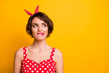 Portrait Of Cheerful Interested Girl Look Copyspace Dream About Incredible Summer Holidays Weekends Bite Lips Teeth Wear Polka-dot Outfit Isolated Over Bright Color Background