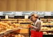 Teenager choosing bread from a supermarket 