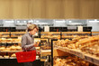 Teenager choosing bread from a supermarket 