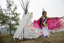 Native American Indian Girl Dancing In Traditional Clothing Outside Teepee