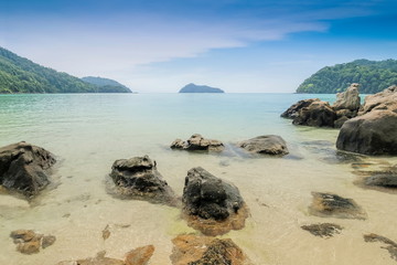 view of many arch rocks in blue-green sea with island and blue sky background, Krating beach, Surin island, Mu Ko Surin National Park, Phang Nga, southern of Thailand.