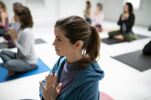 Serene Woman Practicing Yoga With Hands At Heart Center
