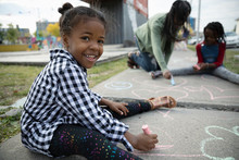 Portrait Smiling, Cute Girl Drawing With Sidewalk Chalk