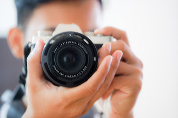 Wall Mural - A blurry photo of  man looking into the camera's viewfinder and taking photo.