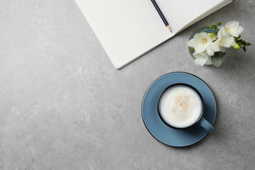 Flat lay composition with coffee on grey table, space for text. Tasty breakfast