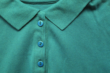 Sticker - Polo shirt close up view of persian green color tone clothes. Dark green and light blue colour mix t-shirt, buttoned up polo top view on the clothing store aisle 