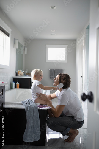 Cute Toddler Daughter Brushing Father S Hair In Bathroom Cute Toddler Daughter Brushing Father S