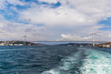 Fototapeta Na sufit - Tourist ship sails on the Golden Horn, Istanbul, Turkey. Scenic sunny panorama of Istanbul city in summer. Beautiful waterfront of Istanbul at sunset. Concept of traveling and vacation in Istanbul.