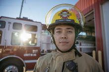 Portrait Confident, Tough Male Firefighter Standing Outside Fire Station
