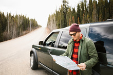 Man With Map Outside SUV At Remote Roadside