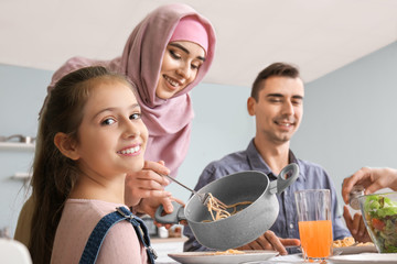 Canvas Print - Muslim family having dinner at home