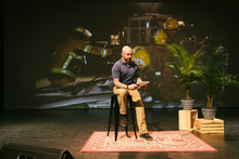 Male Firefighter With Notebook Preparing For Inspirational Speech On Stage