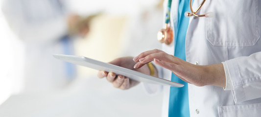 Doctor man in surgery examining young woman