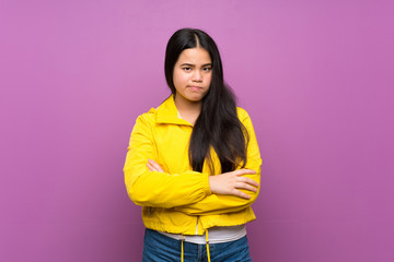 Wall Mural - Young teenager Asian girl over isolated purple background feeling upset