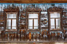 A Part Of An Old Wooden House With Peeling Paint In Russian Style.