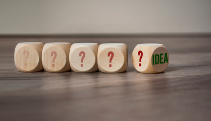 Cubes and dice with Idea on wooden background 