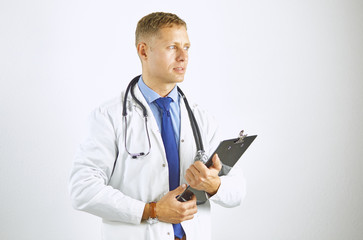 Wall Mural - Young confident doctor in a white coat with a stethoscope