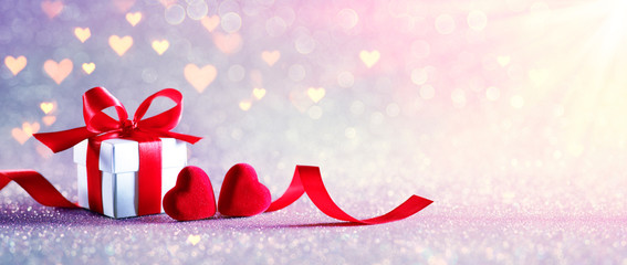 Wall Mural - valentines celebration with gift-box with defocused lights in shiny background