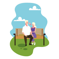 Canvas Print - couple of people in love sitting in the park chair