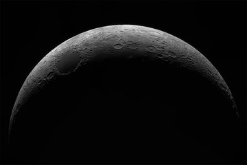 crescent of a young moon with a large increase. moon, view through a telescope. the moon with crater