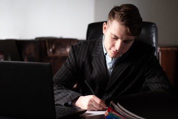 Poster - Businessman at work. The man in the black suit is working. The chief approves the documents. Paperwork. Report preparation. Development of the plan of activity of firm.