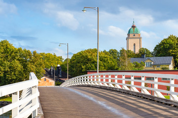 Wall Mural - Helsinki. Finland. Bridge with white wooden railings in the fortress of Sveaborg. The ancient fortress of Suomenlinna. Historical sights of Scandinavia. Walk around Helsinki on a Sunny summer day.