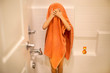 © Asahi Kanazawa - child wearing orange towel after shower