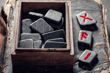 Old fortune teller from rune stones made of Celtic language