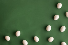White Eggs On Dark Olive Green Background